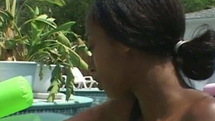 Interracial lesbians having fun in pool